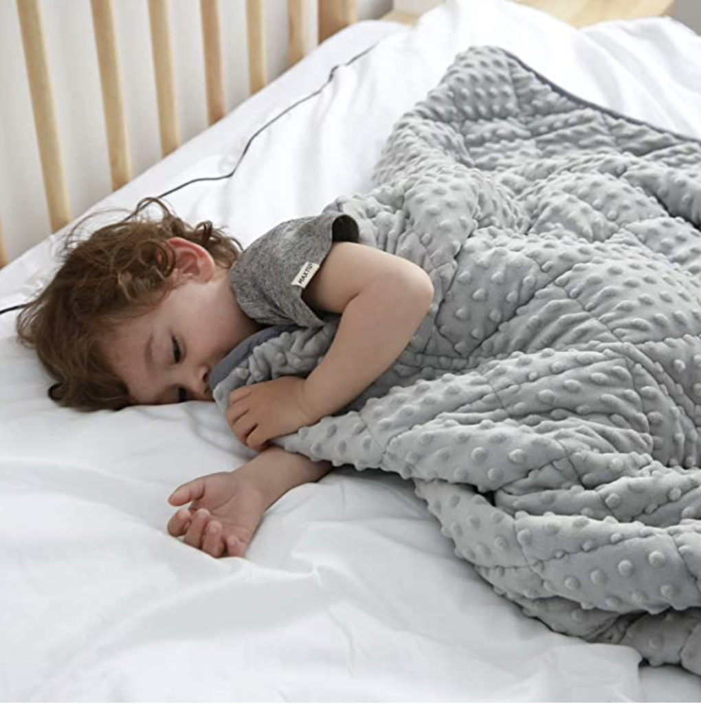 image of sleeping child under weighted blanket